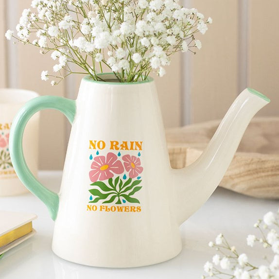 White ceramic flower vase shaped like a long-spouted watering can with contrasting light blue handle and charming No Rain, No Flowers text. 