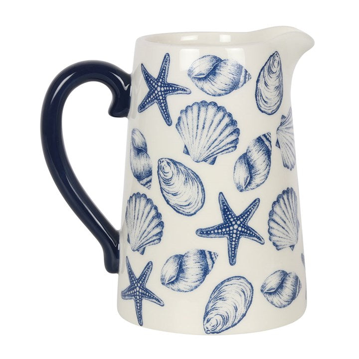 White ceramic flower jug with blue seashell and starfish motif.