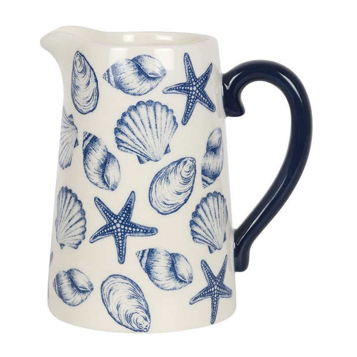 White ceramic flower jug with blue seashell and starfish motif.