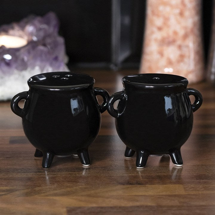 Two black cauldron-shaped salt and pepper shakers.
