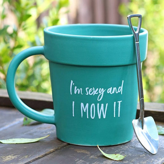 Ceramic green terracotta plant pot shaped mug with shovel-shaped spoon and 'I'm Sexy and I Mow It' text. 