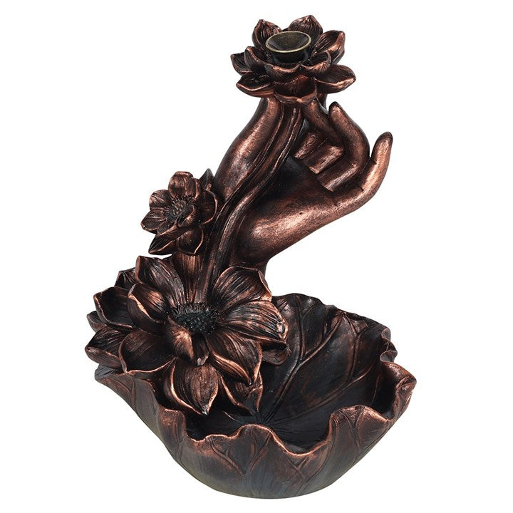 Intricate hand and flowers backflow incense burner in a dark copper effect finish.