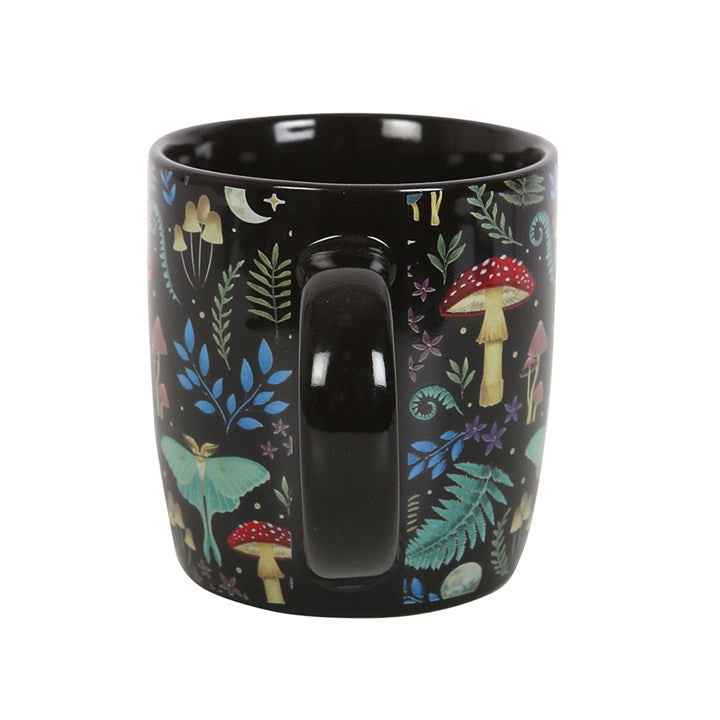 Dark gothic style ceramic mug, with fly agaric, vintage style flora & fauna and mystical luna moths. Side view.