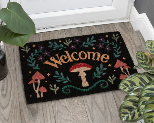 Decorative doormat with charming Welcome text and vintage style fauna on a dark background. 