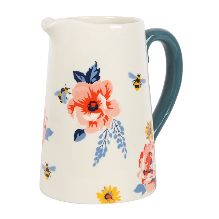 White pitcher with floral and bee illustrations and navy blue handle.