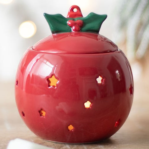 Ceramic wax melter and oil burner shaped like a red festive bauble. 