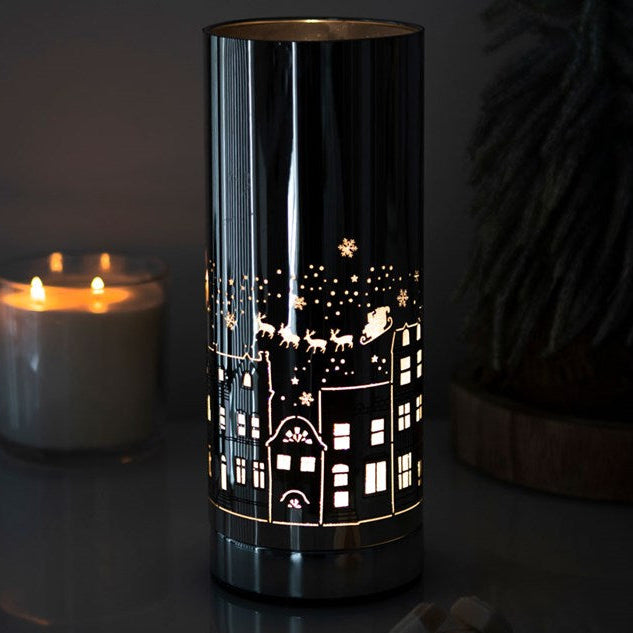 Christmas seasonal electric wax melter and oil burner with Christmas village motif.