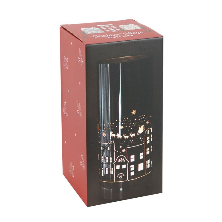 Christmas seasonal electric wax melter and oil burner with Christmas village motif. Presented in a themed box.
