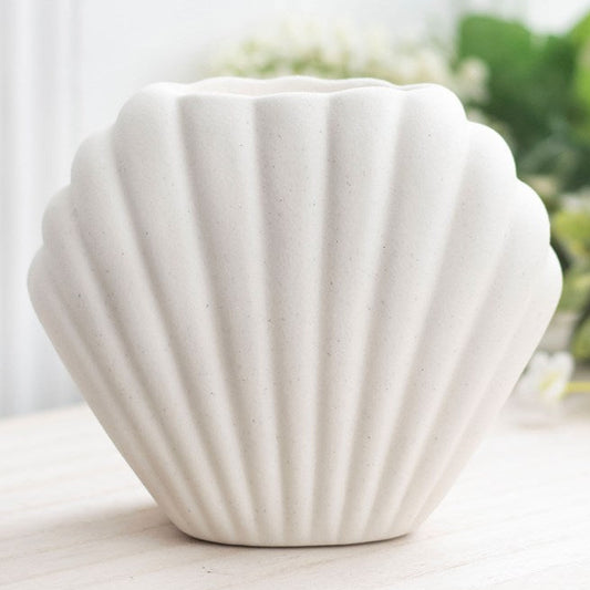 White, shell-shaped ceramic wax melter and oil burner. 
