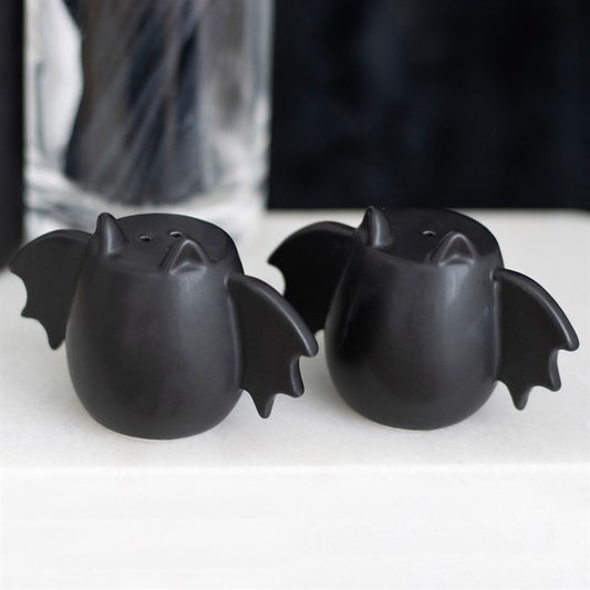 Two black bat-shaped salt and pepper shakers.