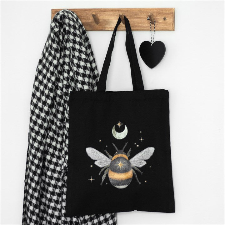 Black tote bag with striking whimsi-gothic forest bee motif.
