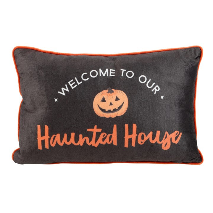 Rectangular Halloween throw cushion. Black background with an orange trim, Welcome to our Haunted House text and jack o' lantern motif.