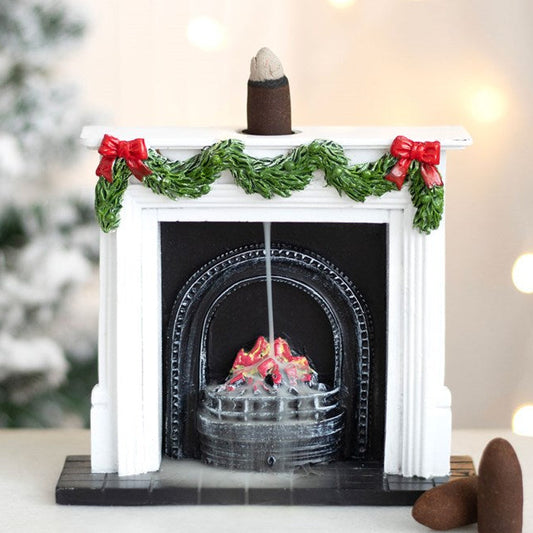 Backflow incense burner, shaped like a traditional fireplace, with garland accents and a roaring fire. 