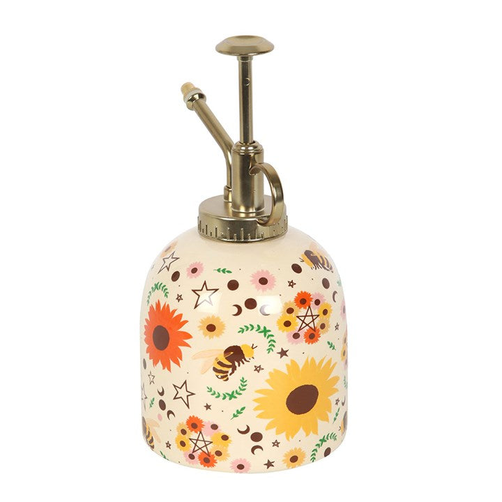 Ceramic plant mister finished with a summer-solstice inspired motif, including sunflowers, bees and phases of the moon, and a gold-effect spray pump.