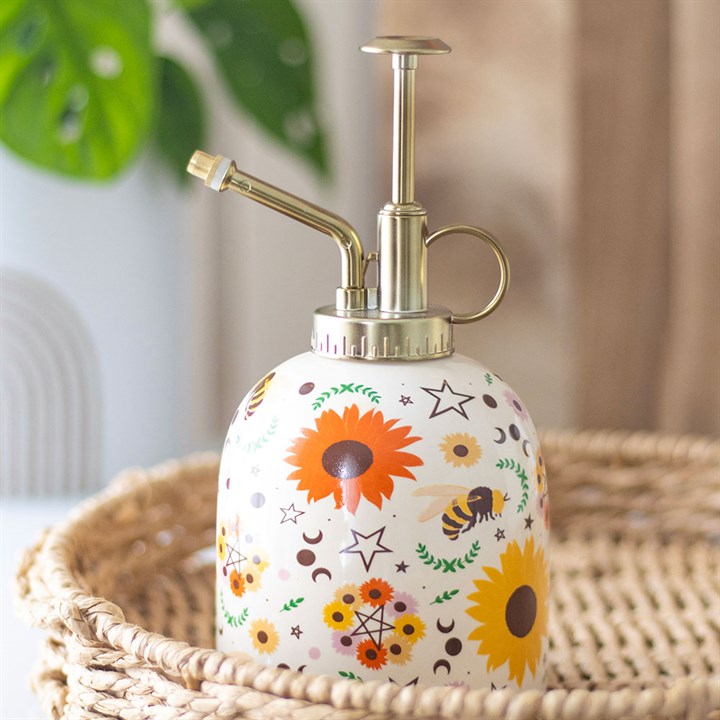 Ceramic plant mister finished with a summer-solstice inspired motif, including sunflowers, bees and phases of the moon, and a gold-effect spray pump.