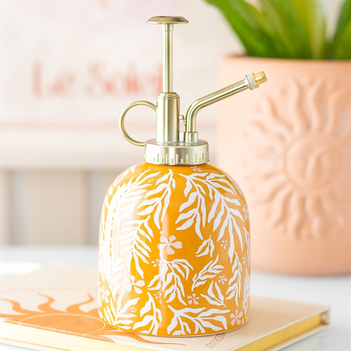 Ceramic yellow plant mister with a white leaf motif and silver-effect spray pump.