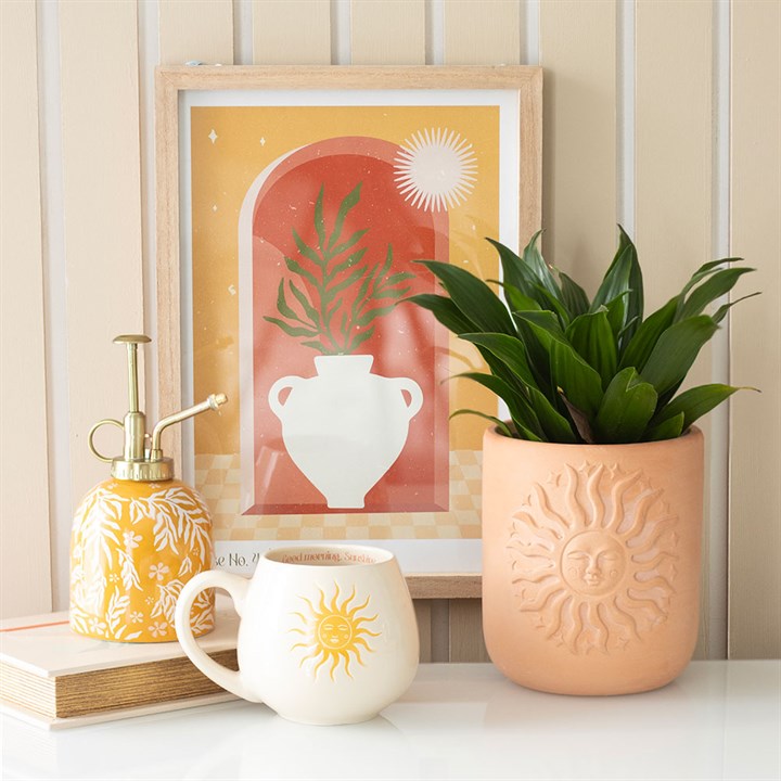 Ceramic yellow plant mister with a white leaf motif and silver-effect spray pump. Presented alongside other items from the same range. 