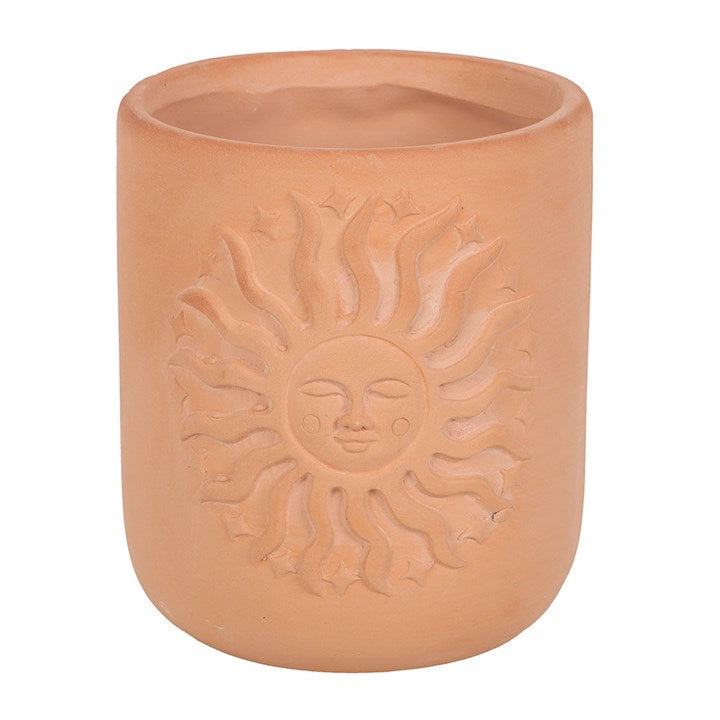 Terracotta plant pot with charming embossed sunburst design.