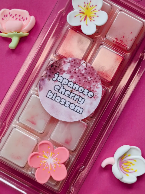 Japanese Cherry Blossom coconut wax melt. Light pink and cream ombre snap bar with bright pink shimmer accents. 