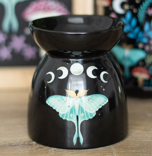 Black gloss ceramic wax melter and oil burner with a luna moth moon-phase design. 