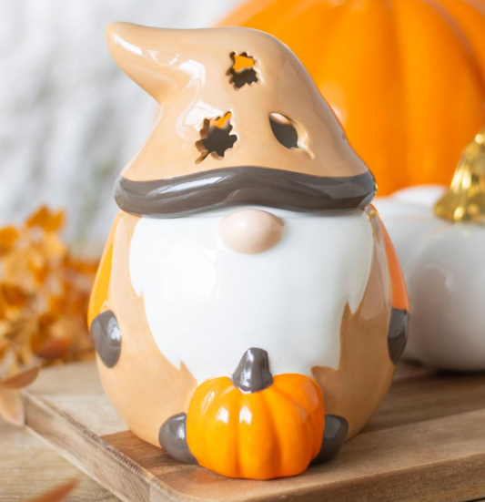 Autumnal ceramic gonk wax melter and oil burner with leaf-shaped cutouts and pumpkin.