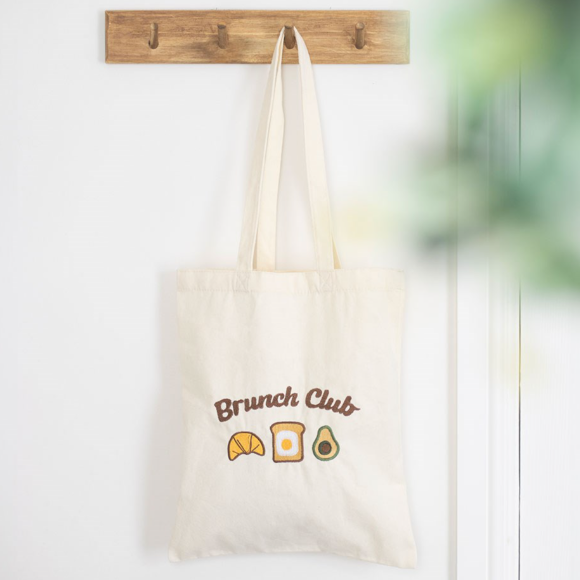 Canvas reusable tote bag with Brunch Club text and croissant, egg on toast and avocado design.