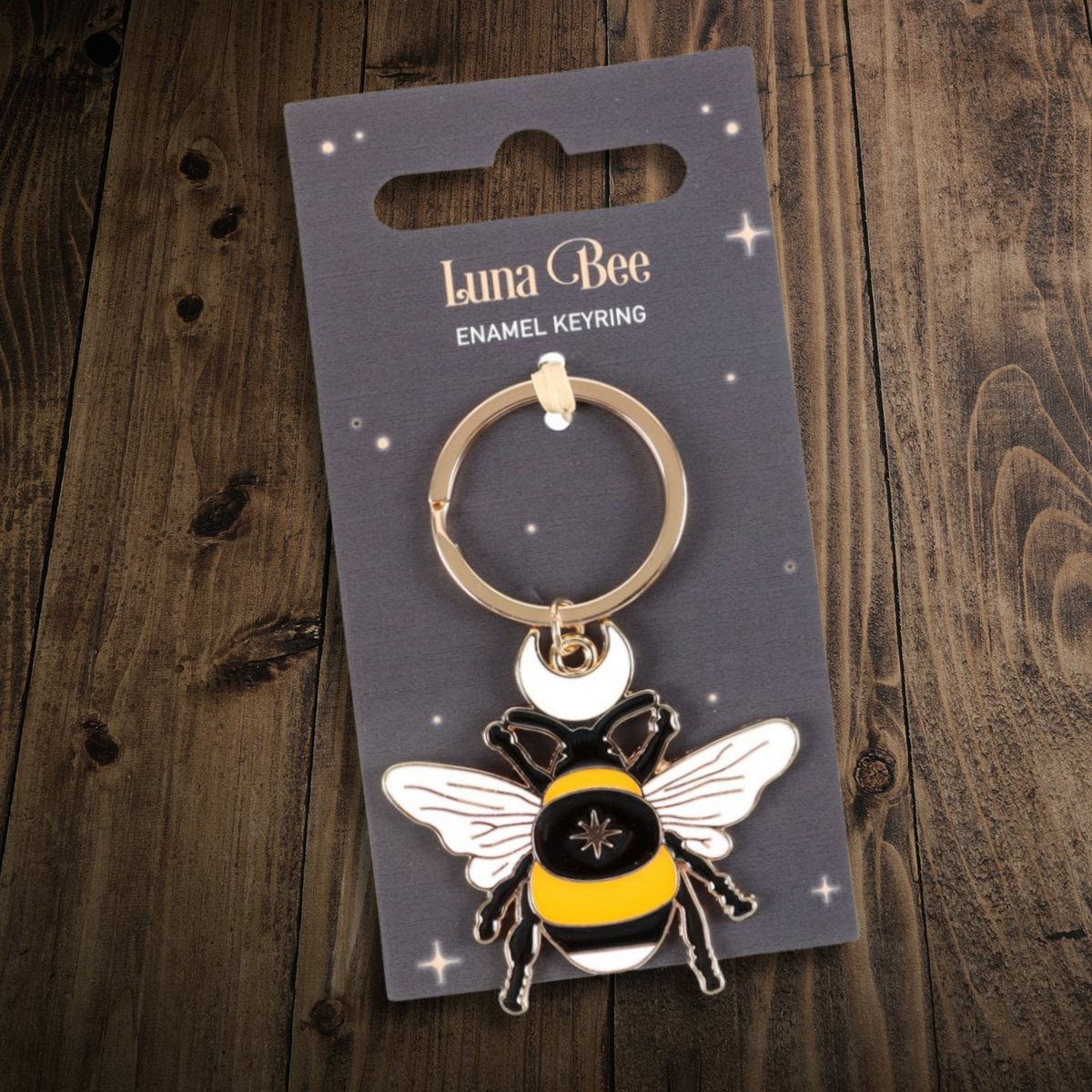Charming enamel keyring featuring a plump Luna Bee, with celestial themed accents, presented on a themed backing card. 