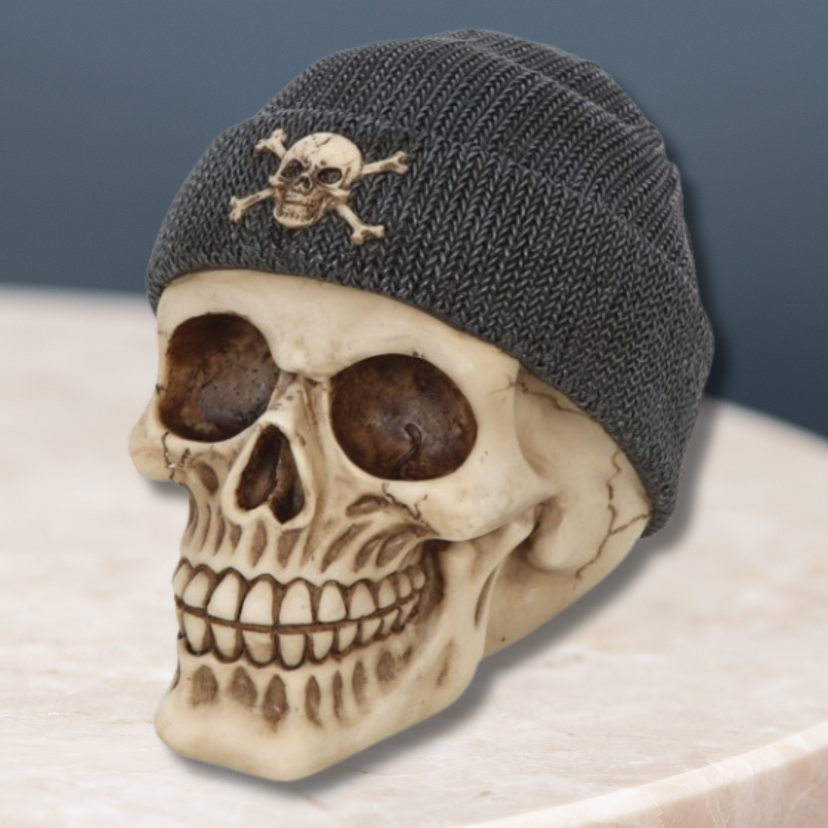 A realistic skull decoration wearing a black beanie, finished with a skull-and-crossbones accent.