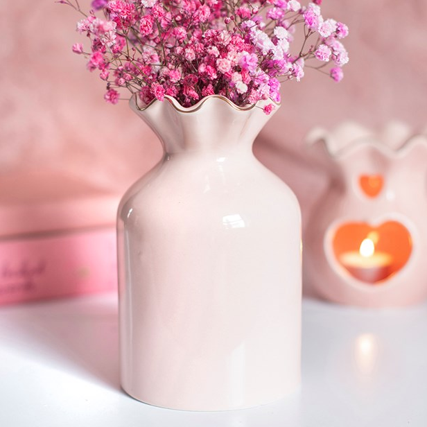 Muted pink fluted flower vase with scalloped edge top. 