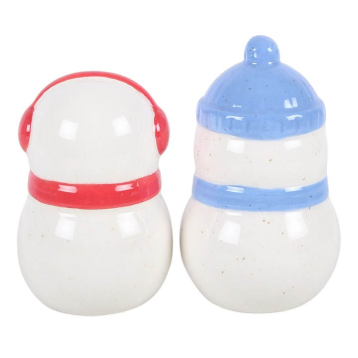 Pair of ceramic snowman shaped salt and pepper shakers, finished with complementing red and blue accessories. 