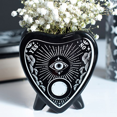 Black planchette shaped flower vase, finished with celestial accents. 