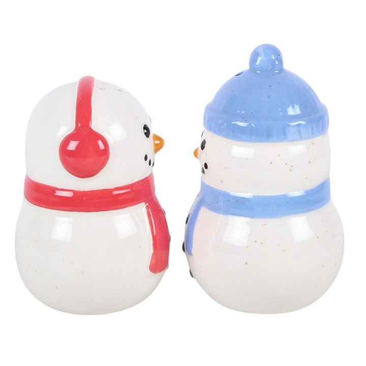 Pair of ceramic snowman shaped salt and pepper shakers, finished with complementing red and blue accessories. 