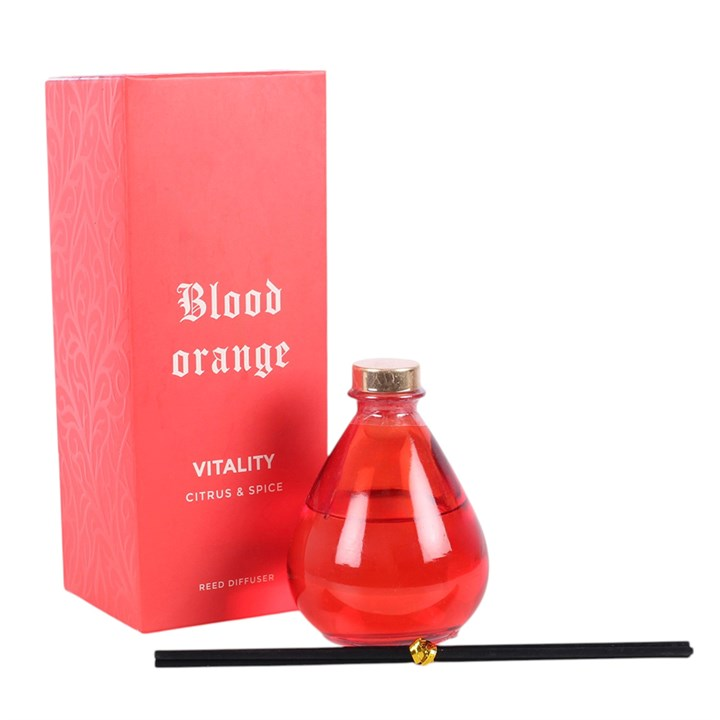 Blood Orange reed diffuser, presented in a deep orange teardrop bottle with black reeds. 