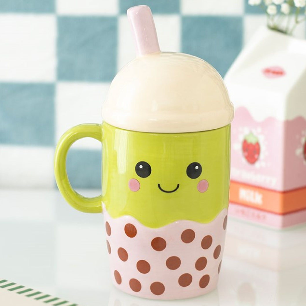 Ceramic mug shaped like an adorable Kawaii-inspired boba! Its domed pastel pink lid has a straw and the mug itself has a cute smiley face.