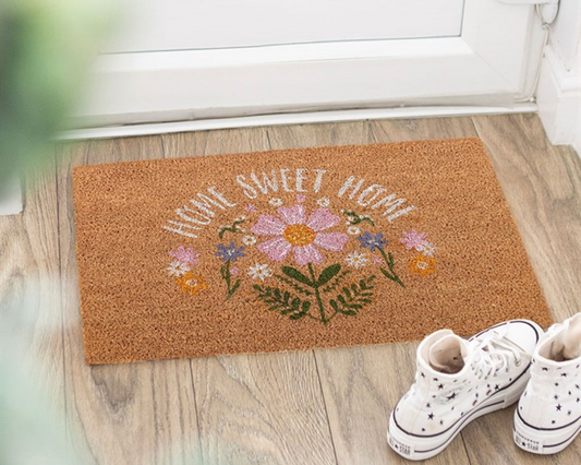 Decorative doormat with 'Home Sweet Home' and daisy design on a natural fibres background.