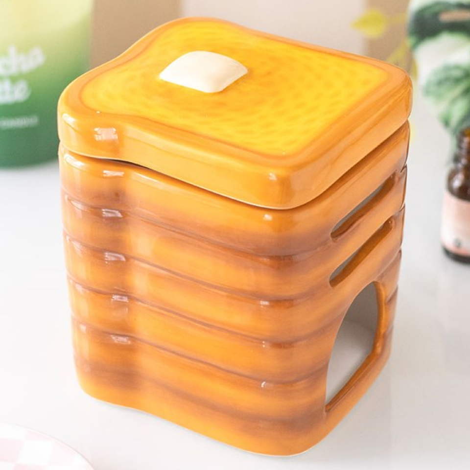 Stack of toast shaped ceramic wax melter and oil burner.