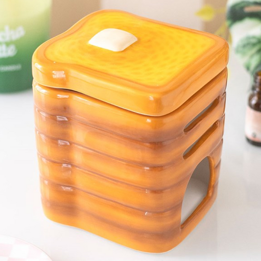 Stack of toast shaped ceramic wax melter and oil burner.