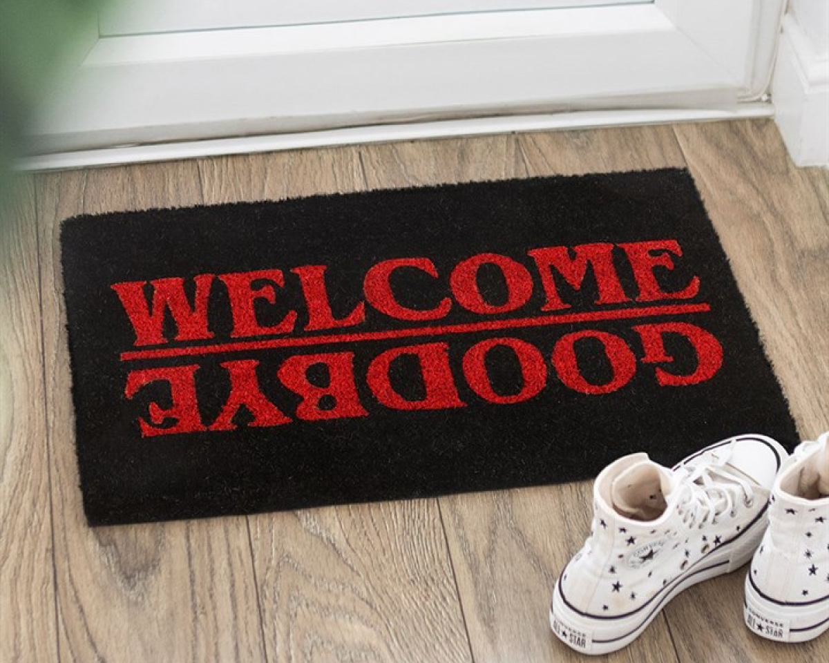 Black natural-fibre door mat, designed with striking red Welcome / Goodbye text on a jet black background. Stranger Things-inspired design. 
