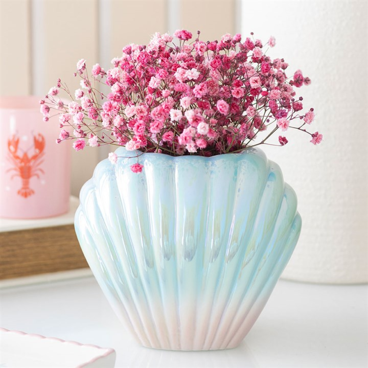 Iridescent glazed sea-shell flower vase with pink and blue ombre design.