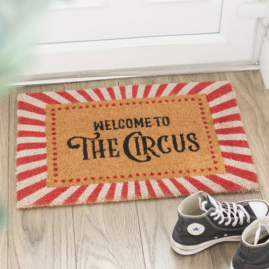Doormat with Welcome To The Circus text, embellished with red and white stripes.