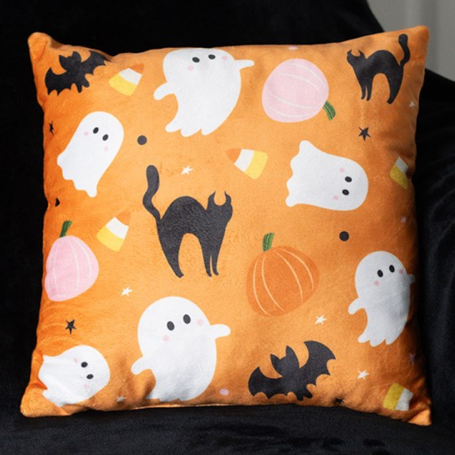 Square orange throw cushion with an adorable Halloween theme, including ghosts, cats, bats, candy corns and pumpkins. 