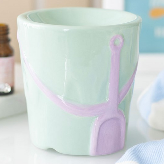 Pastel coloured beach bucket shaped wax melter and oil burner. 