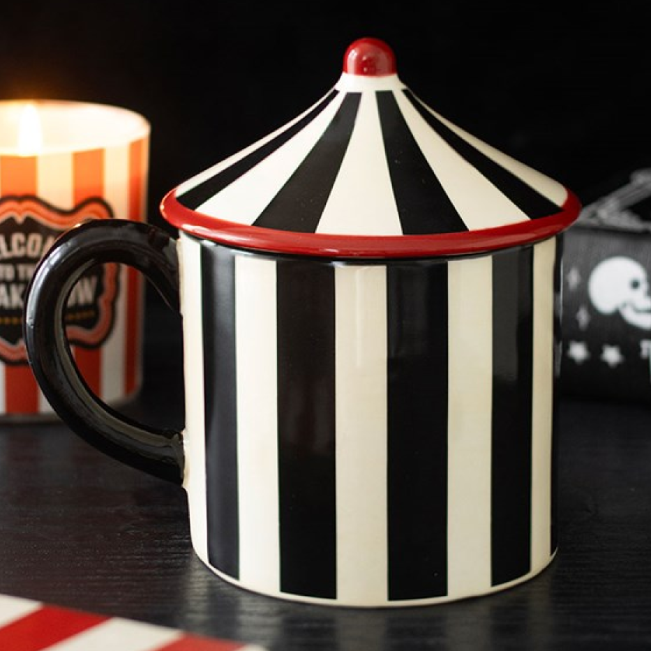 Monochrome striped circus tent-shaped ceramic mug with a pointed lid. 