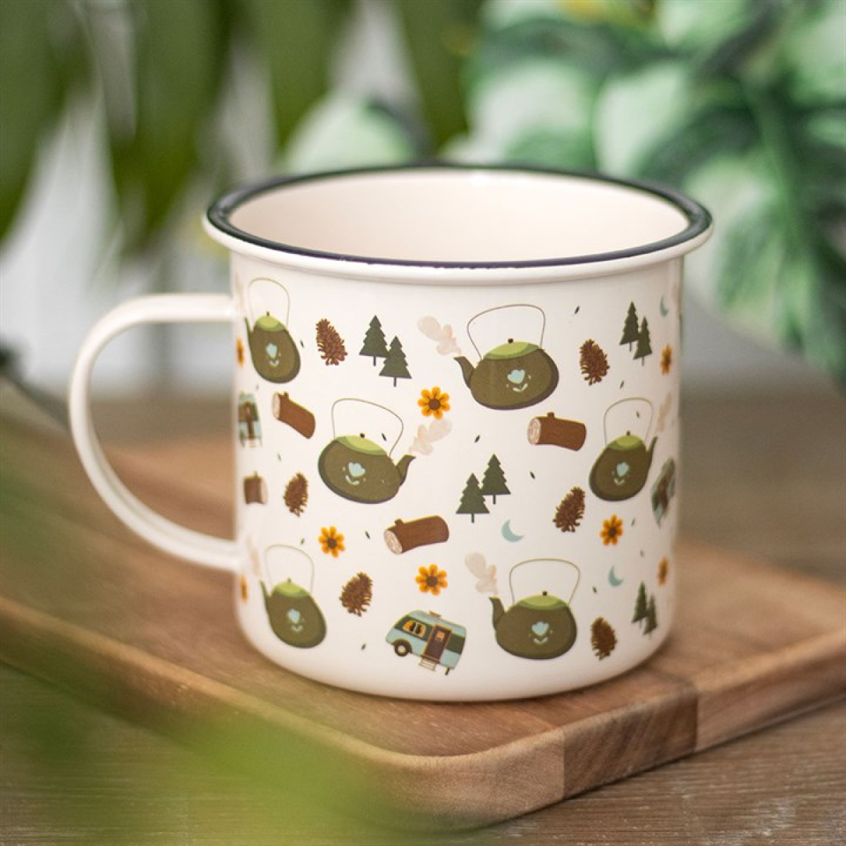 Enamel mug with camping-inspired pattern on a white background.
