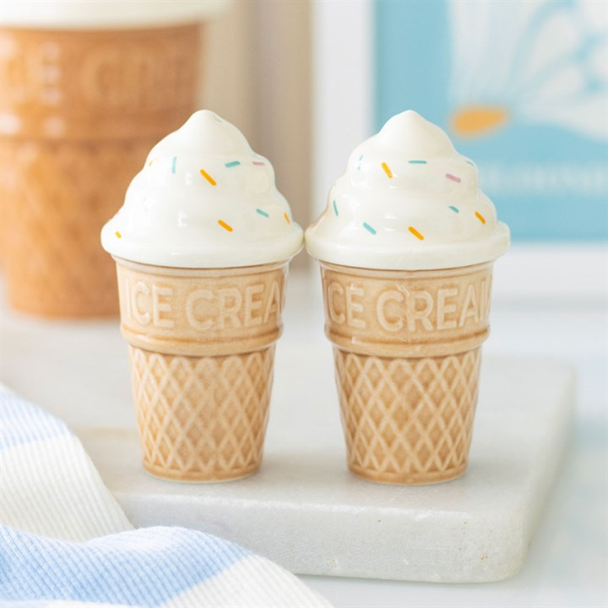 ceramic salt and pepper shaker set shaped like traditional ice cream cones with sprinkle detailing.