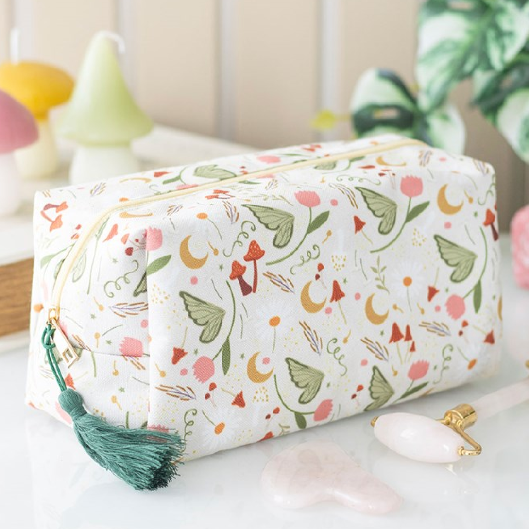 Zip-close polyester makeup bag with a whimsical fairy-lore design and teal tassel zip.