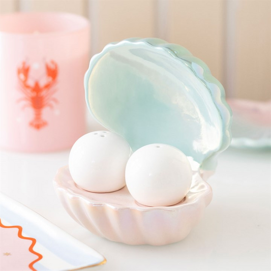 pearl-shaped salt and pepper shakers stored inside a clam-shell shaped holder