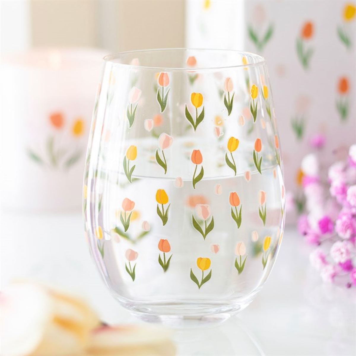 Clear rounded water glass covered in a tulip motif. 