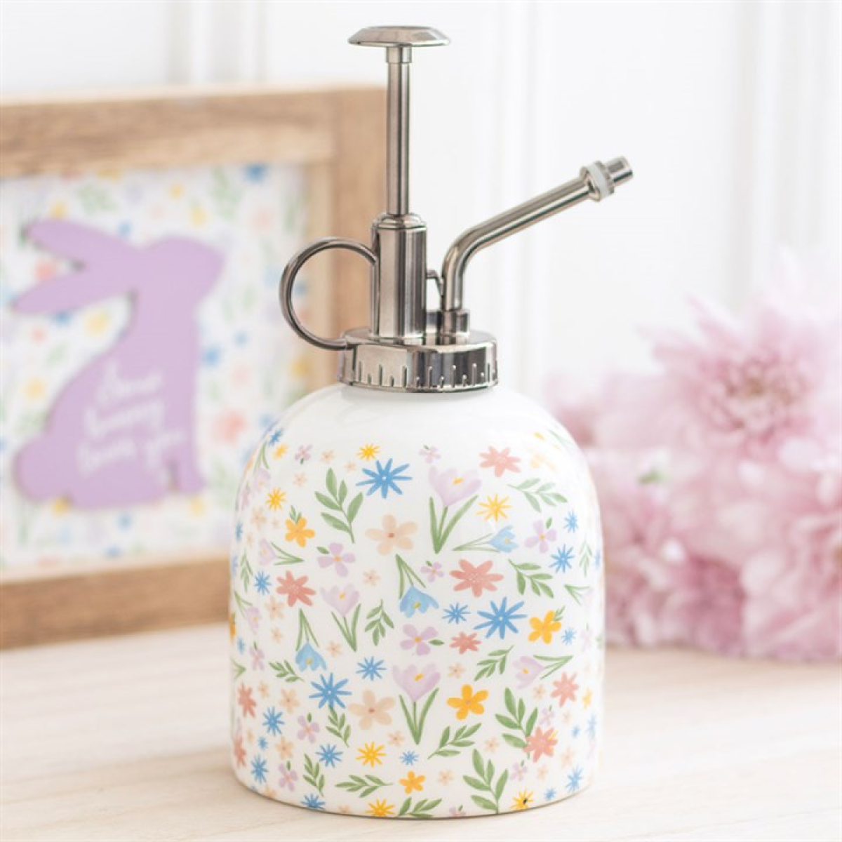 Ceramic plant mister finished with a pastel-hued spring florals motif and a silver effect spray pump. 