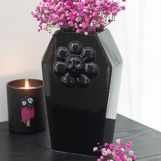 Black coffin-shaped flower vase with quirky flower embossed design. 